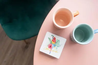 a pink table with a cup of coffee and a bird card at Sundown Sanctuary in National City in National City