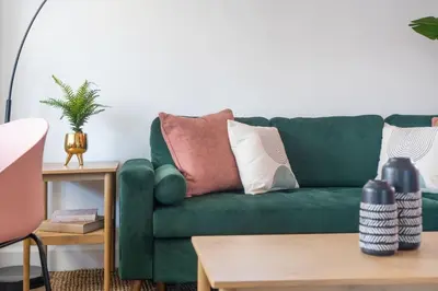 a green couch with pillows on it in a living room at Sundown Sanctuary in National City in National City