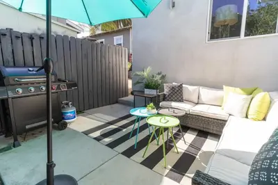 a patio with a couch and a table with an umbrella at North Park Retreat - Trendy - Tranquil - Vibrant in San Diego