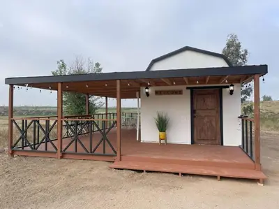 a building with a porch and a door on it at Modern wine country barn house in Temecula