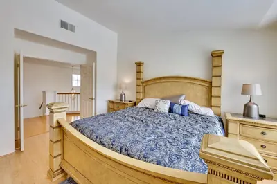 a bedroom with a large bed with a blue comforter at Lake Elsinore Vacation Rental about 4 Mi to the Lake! in Lake Elsinore