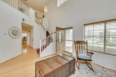 a living room with a chair and a wooden table at Lake Elsinore Vacation Rental about 4 Mi to the Lake! in Lake Elsinore