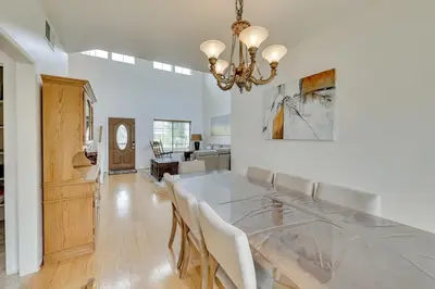 a dining room with a table and a chandelier at Lake Elsinore Vacation Rental about 4 Mi to the Lake! in Lake Elsinore