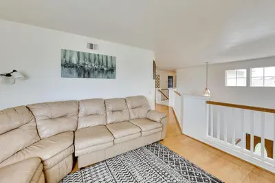 a white living room with a couch and a rug at Lake Elsinore Vacation Rental about 4 Mi to the Lake! in Lake Elsinore