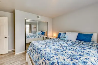 a bedroom with a large bed with blue pillows at Lake Elsinore Vacation Rental about 4 Mi to the Lake! in Lake Elsinore