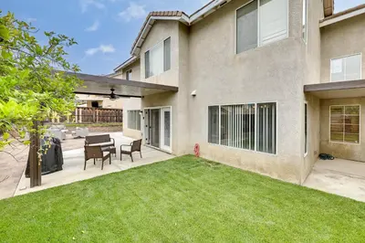 a backyard of a house with a table and chairs at Lake Elsinore Vacation Rental about 4 Mi to the Lake! in Lake Elsinore