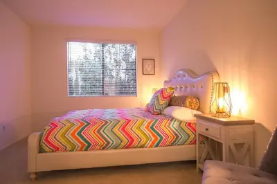 a small bedroom with a bed and a window at Irvine Spectrum/2 Bedrooms/2 Bathrooms/Apartment/pool/gym in Irvine
