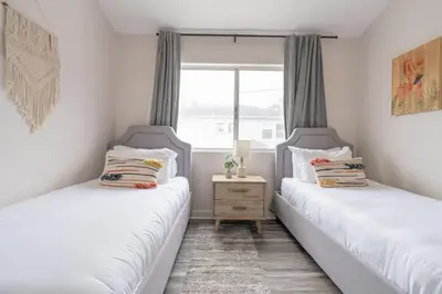 two twin beds in a room with a window at Sunlit La Jolla Village Gem with Peak Ocean Views in San Diego