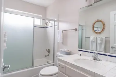 a white bathroom with a toilet and a sink at Sunlit La Jolla Village Gem with Peak Ocean Views in San Diego