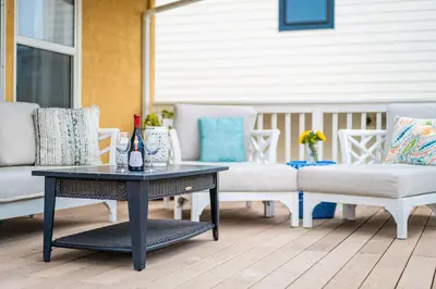 a patio with a table and couches on a porch at Sunlit La Jolla Village Gem with Peak Ocean Views in San Diego