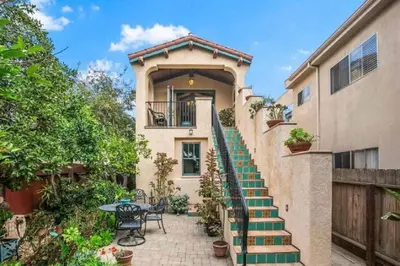a house with stairs leading up to a building at Spanish Style Cozy Studio in San Diego