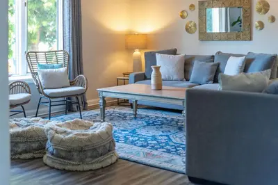 a living room with a couch and a table and chairs at La Jolla Village's Premier Haven in San Diego
