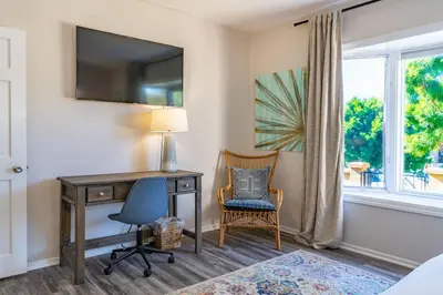 a bedroom with a desk and a chair and a window at La Jolla Village's Premier Haven in San Diego