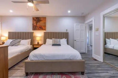 a bedroom with two beds and a ceiling fan at La Jolla Village's Premier Haven in San Diego