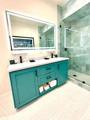 a blue bathroom with a sink and a mirror at AZUL on Avenida Del Mar (1/2 Mile to the PIER!) in San Clemente