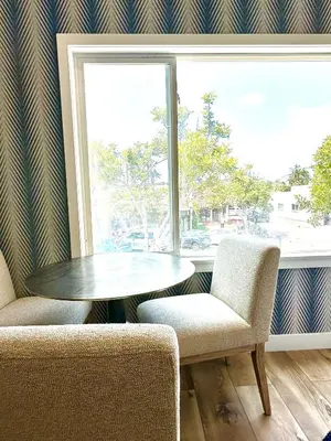 a table and two chairs in a room with a window at AZUL on Avenida Del Mar (1/2 Mile to the PIER!) in San Clemente