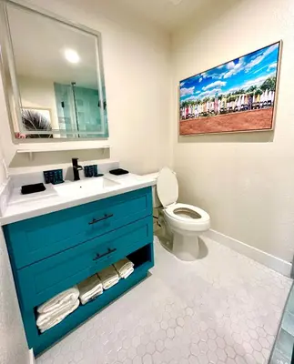 a bathroom with a blue sink and a toilet at AZUL on Avenida Del Mar (1/2 Mile to the PIER!) in San Clemente