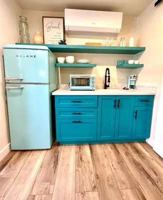 a kitchen with blue cabinets and a blue refrigerator at AZUL on Avenida Del Mar (1/2 Mile to the PIER!) in San Clemente