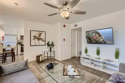 a living room with a couch and a ceiling fan at NEW - 6br home in Oceanside w Games BBQ Outdoor Seating in Oceanside