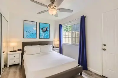 a bedroom with a bed and a ceiling fan at NEW - 6br home in Oceanside w Games BBQ Outdoor Seating in Oceanside