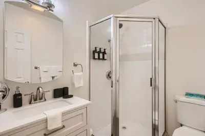 a white bathroom with a shower and a sink at NEW - 6br home in Oceanside w Games BBQ Outdoor Seating in Oceanside