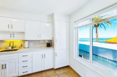 a kitchen with a window with a view of the ocean at Seas the Day by Cardo - La Jolla Beachfront in San Diego