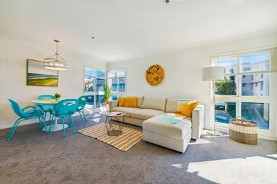 a living room with a couch and a table at Seas the Day by Cardo - La Jolla Beachfront in San Diego