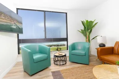 a living room with two chairs and a couch at Sunny on the Ocean - Beachfront- Pacific Beach in San Diego