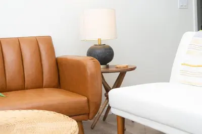a living room with a chair and a lamp on a table at Sunny on the Ocean - Beachfront- Pacific Beach in San Diego