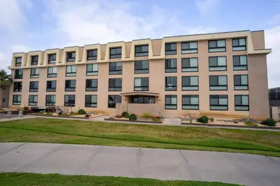 a large building with a lawn in front of it at Sunny on the Ocean - Beachfront- Pacific Beach in San Diego