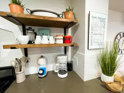 a kitchen counter with a coffee maker on a shelf at IB Seaside Paradise w/ Ocean Views! in Imperial Beach