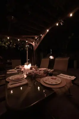 a table with candles and plates of food on it at TinyHome at the Sanctuary in Lakeside