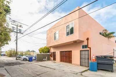 a pink building with a garage at Living Lux in La Jolla - Beach - AC - Shops in San Diego