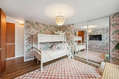 a bedroom with two bunk beds and a tv at Living Lux in La Jolla - Beach - AC - Shops in San Diego
