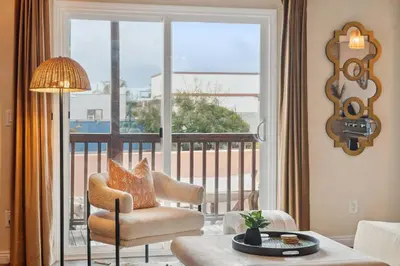 a living room with a chair and a large window at Living Lux in La Jolla - Beach - AC - Shops in San Diego