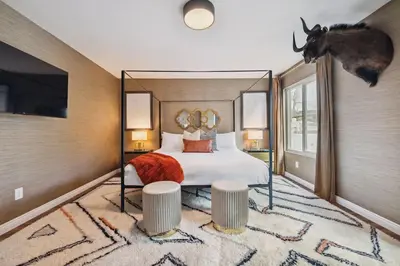 a bedroom with a bed with a deer head on the wall at Living Lux in La Jolla - Beach - AC - Shops in San Diego