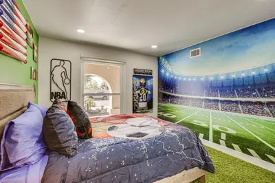 a bedroom with a football game mural on the wall at Luxe Family Home in Bonita with Private Pool and Spa! in Bonita