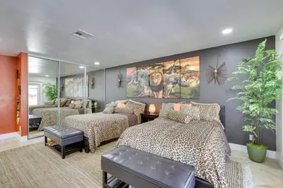 a bedroom with two beds and a mirror at Luxe Family Home in Bonita with Private Pool and Spa! in Bonita