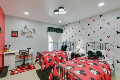 a childs bedroom with two beds and a desk at Luxe Family Home in Bonita with Private Pool and Spa! in Bonita