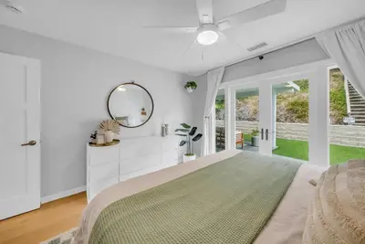 a white bedroom with a large bed and a mirror at Colorful & Comfy Gem Close to Beach - Yard - Pkg in Encinitas