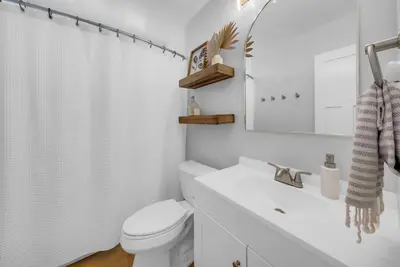 a white bathroom with a toilet and a sink at Colorful & Comfy Gem Close to Beach - Yard - Pkg in Encinitas