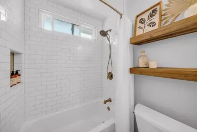 a white bathroom with a tub and a toilet at Colorful & Comfy Gem Close to Beach - Yard - Pkg in Encinitas
