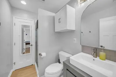 a white bathroom with a toilet and a sink at Colorful & Comfy Gem Close to Beach - Yard - Pkg in Encinitas