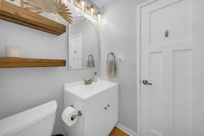 a bathroom with a toilet and a sink and a mirror at Colorful & Comfy Gem Close to Beach - Yard - Pkg in Encinitas