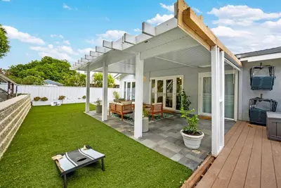 a backyard with a white pergola and green grass at Colorful & Comfy Gem Close to Beach - Yard - Pkg in Encinitas