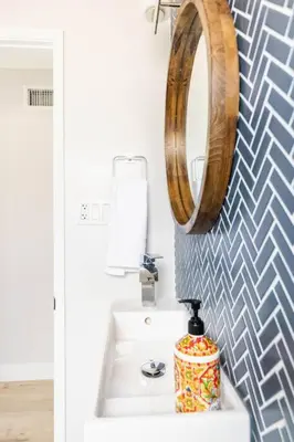 a bathroom with a sink and a mirror on the wall at Beach Home W AC- 5 BR - Free Parking - EV Charge in San Diego