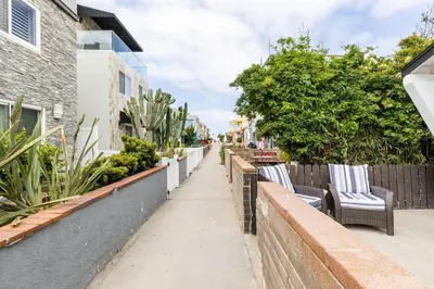 a sidewalk with two chairs and a fence at Beach Home W AC- 5 BR - Free Parking - EV Charge in San Diego