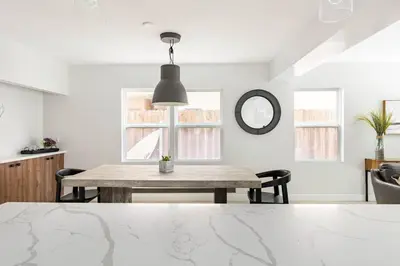 a dining room with a table and a mirror at Beach Home W AC- 5 BR - Free Parking - EV Charge in San Diego