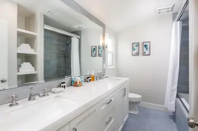 a white bathroom with a sink and a toilet at 608 S Bayfront in Newport Beach