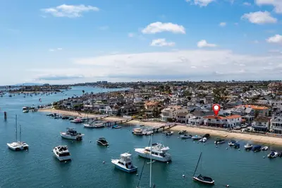 a group of boats are docked in a harbor at 608 S Bayfront in Newport Beach